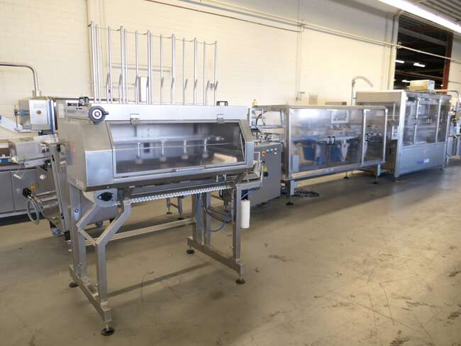 Tramper filling- and traysealing line